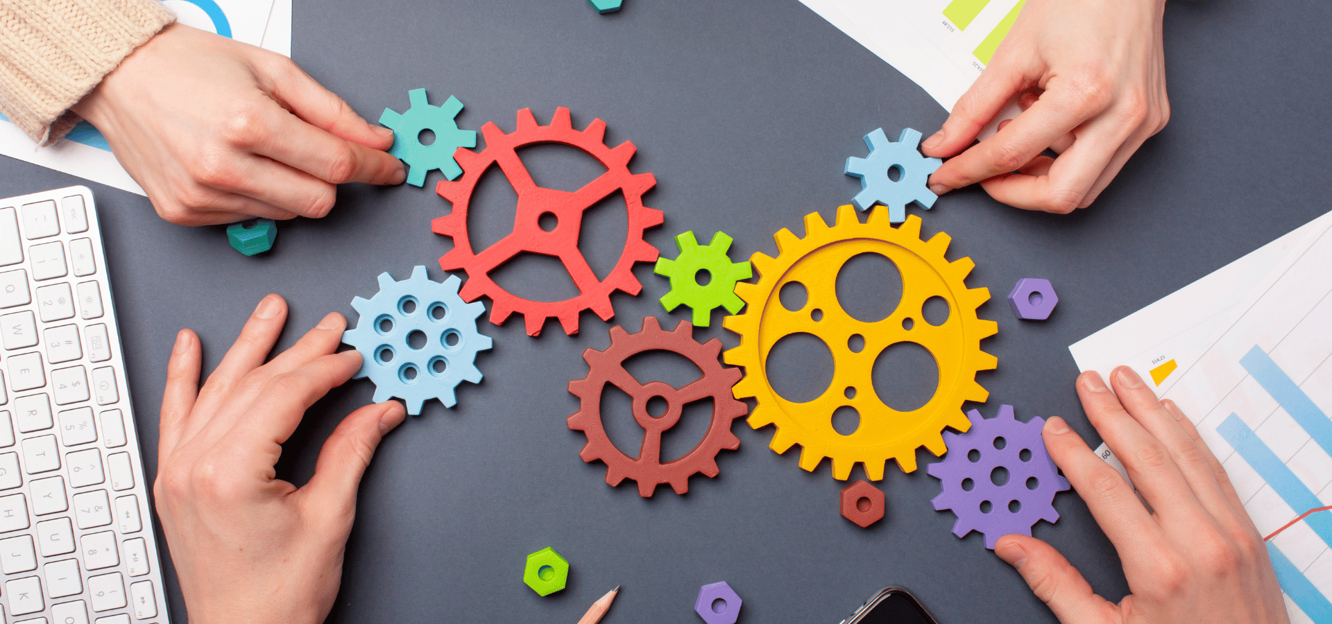 Interlocking Collaborative Gears over Dark Slate Desk